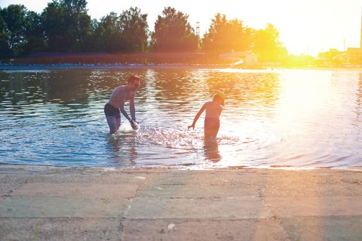 Father and his baby boy playing at the water