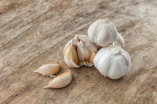 Fresh garlic isolated on wooden background .