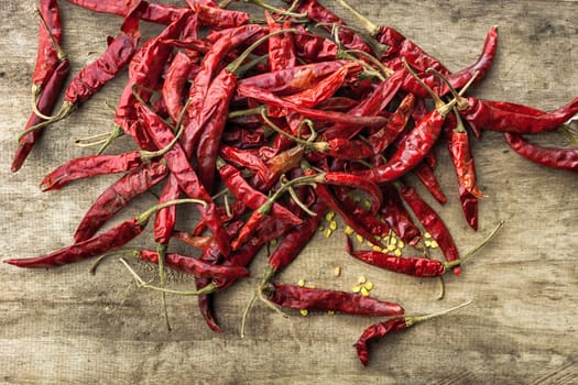 Dried red chili pepper on wooden background .