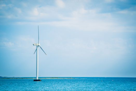 Single windmill in the oceran by the coast