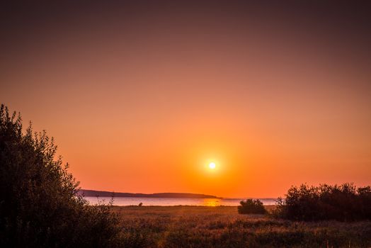 Countryside lake with a sunrise in the late summer