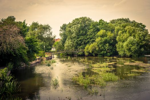 Idyllic countryside lake with a small bridge