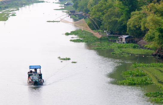 Cargo boat floating on the Mekong river, southern Vietnam.