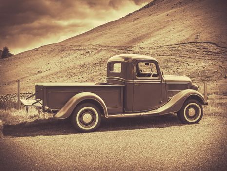 Retro Style Sepia Image Of A Vintage Truck In The Countryside