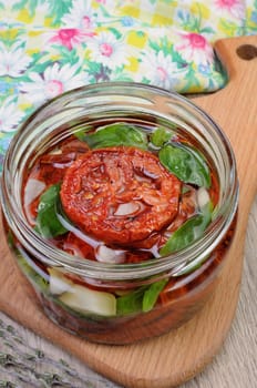 Slices of dried tomatoes with garlic and basil oil