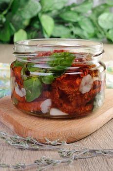 Slices of dried tomatoes with garlic and basil oil