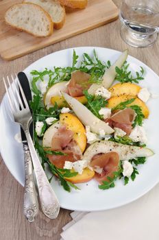 Light salad of pear, peach and ham, feta, arugula