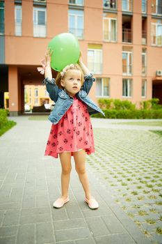 Portrait of funny little child, adorable blonde toddler girl outdoors