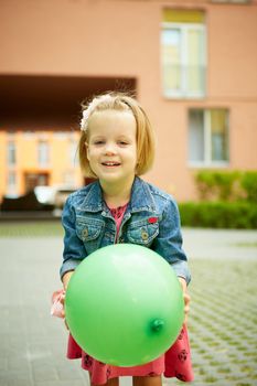 Portrait of funny little child, adorable blonde toddler girl outdoors