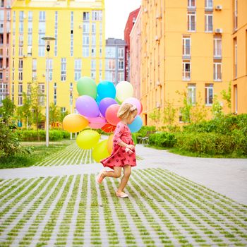 inspiration, happy little girl outdoors with balloons