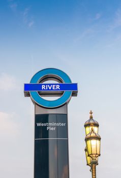 LONDON - JUNE 11, 2015: Westminster Pier sign with lamp post.