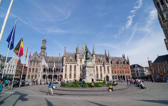 Bruges, Belgium - May 11, 2015: Tourist on Grote Markt square in Bruges, Belgium on May 11, 2015. The historic city centre is a prominent World Heritage Site of UNESCO.