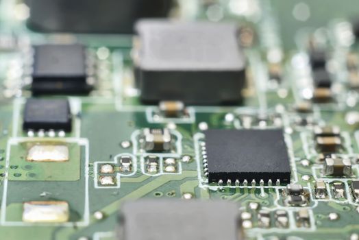 many macro zoomed black processors on green circuit board (computer hardware)