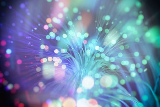 colored particles fly in space of the optical fiber and circling ( abstract blur background  )