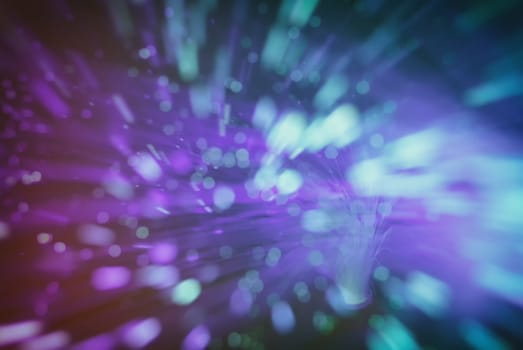 colored particles fly in space of the optical fiber and circling ( abstract blur background  )