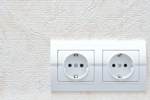two white new electrical sockets (rosette) on wall