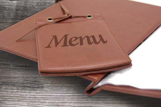 brown leather menu in a restaurant or cafe on wooden background