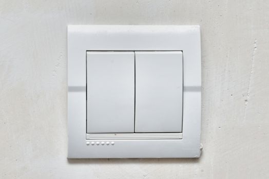 light white  power switch on the wall ( lighting switch )