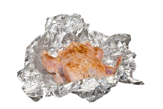 crude chicken preparation with spices for grill in foil
