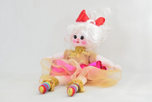 pretty girl's doll sitting over white