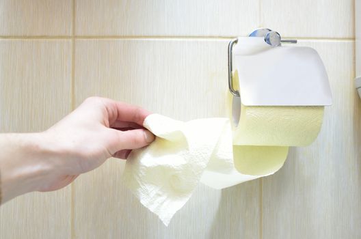 Toilet yellow paper and toilet paper holder.