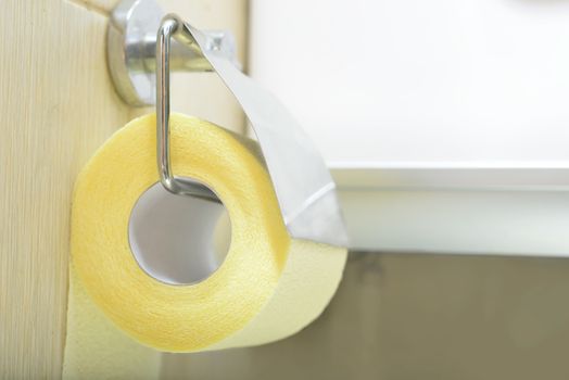 Toilet yellow paper and toilet paper holder.