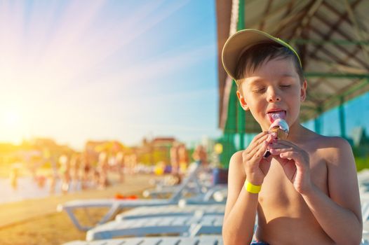 Baby boy with ice-cream at the beach