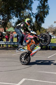 VICTORIA/AUSTRALIA - SEPTEMBER 2015: Stunt motorcycle rider performing at a local car show on the 13 September 2015 in Corowa.