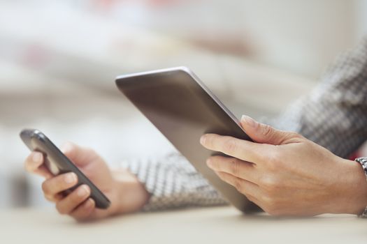 Businesswoman at office with digital tablet and smartphone
