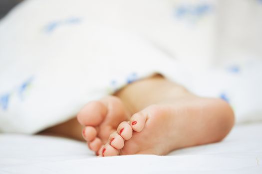 Feet of sleeping woman. Horizontal photo