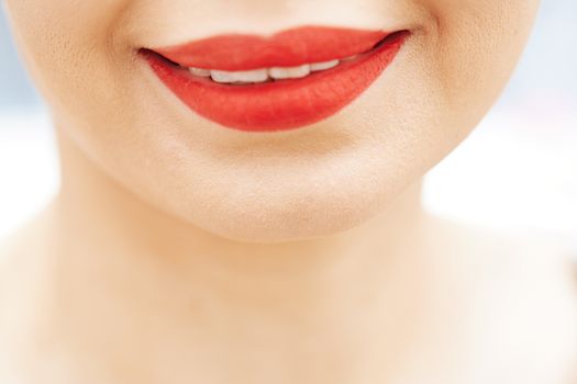 Smiling woman with red lips. Close-up view on face