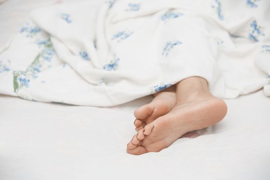 Feet of sleeping woman. Horizontal photo