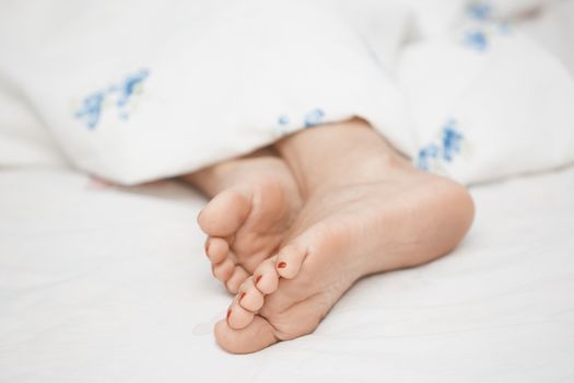 Feet of sleeping woman. Horizontal photo