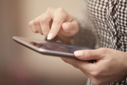 Hands of woman using digital tablet