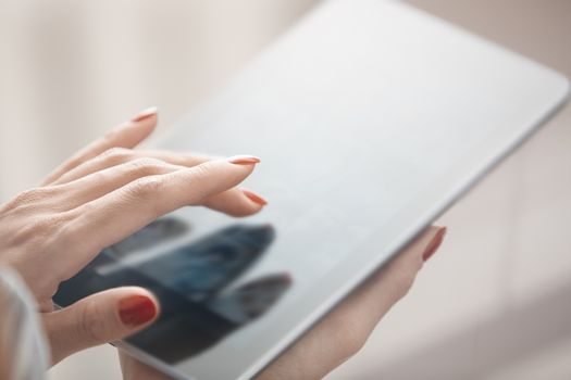 Hands of woman using digital tablet