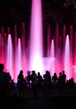 People wondering colourful fountain in Budapest, Hungary