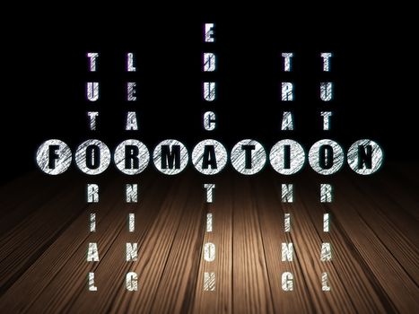 Learning concept: Glowing word Formation in solving Crossword Puzzle in grunge dark room with Wooden Floor, black background
