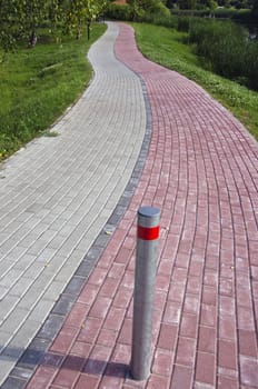 Red and grey bricks pedestrian and bicycle way by the river