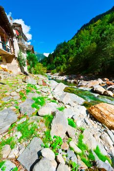Medieval City on the Banks of a Mountain River in Italian Alps