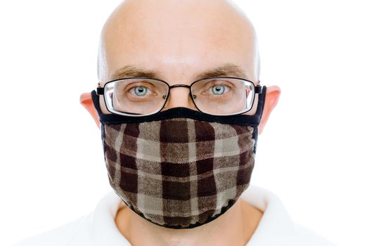 Bald man on a white background in the fashion warm medical mask