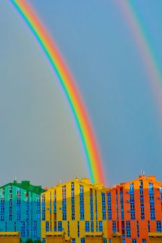 Double rainbow over bright colored houses. Kiev city