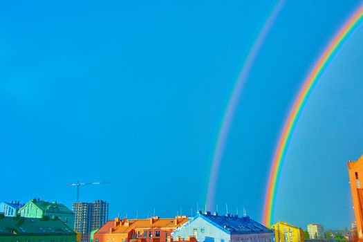 Double rainbow over bright colored houses. Kiev city