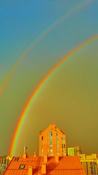 Double rainbow over bright colored houses. Kiev city