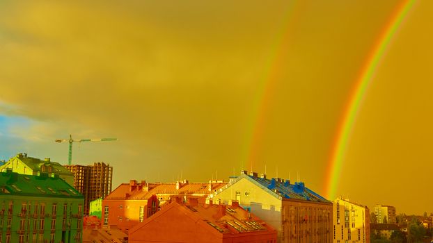 Double rainbow over bright colored houses. Kiev city