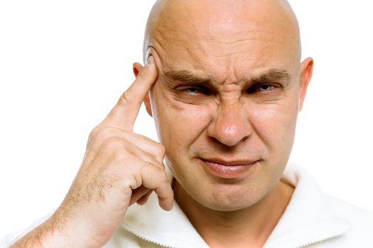 Bald man holding his finger to his temple. Headache or problem