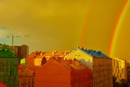 Double rainbow over bright colored houses. Kiev city