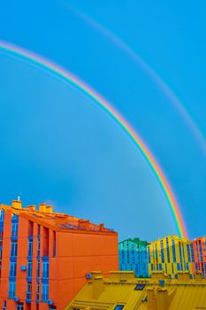 Double rainbow over bright colored houses. Kiev city