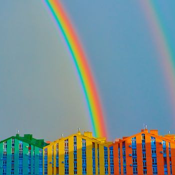 Double rainbow over bright colored houses. Kiev city