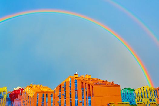 Double rainbow over bright colored houses. Kiev city