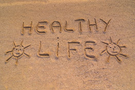 In the picture the words on the sand "Healty life".